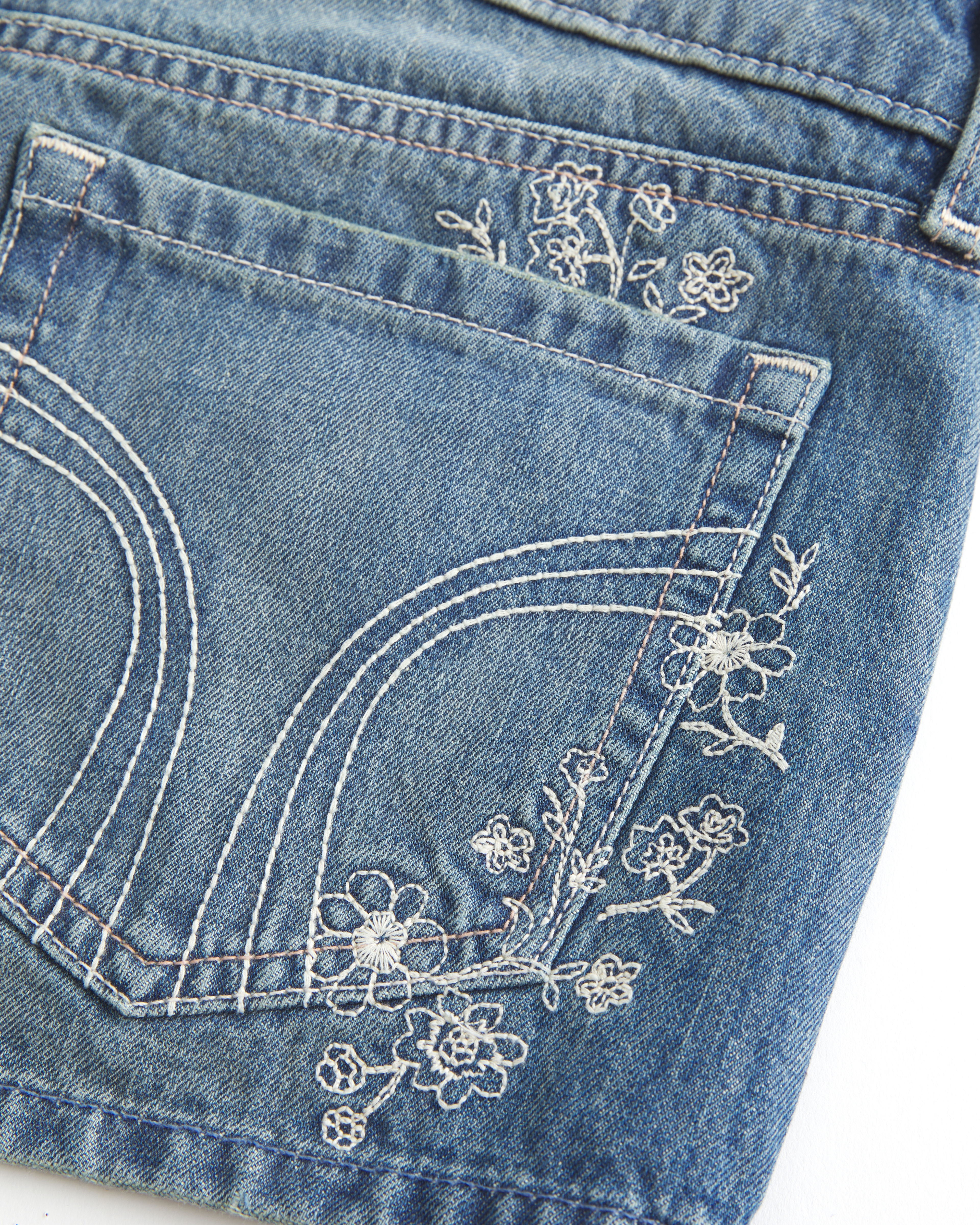 Ultra Low-Rise Medium Wash Floral Embroidered Denim Mini Shorts