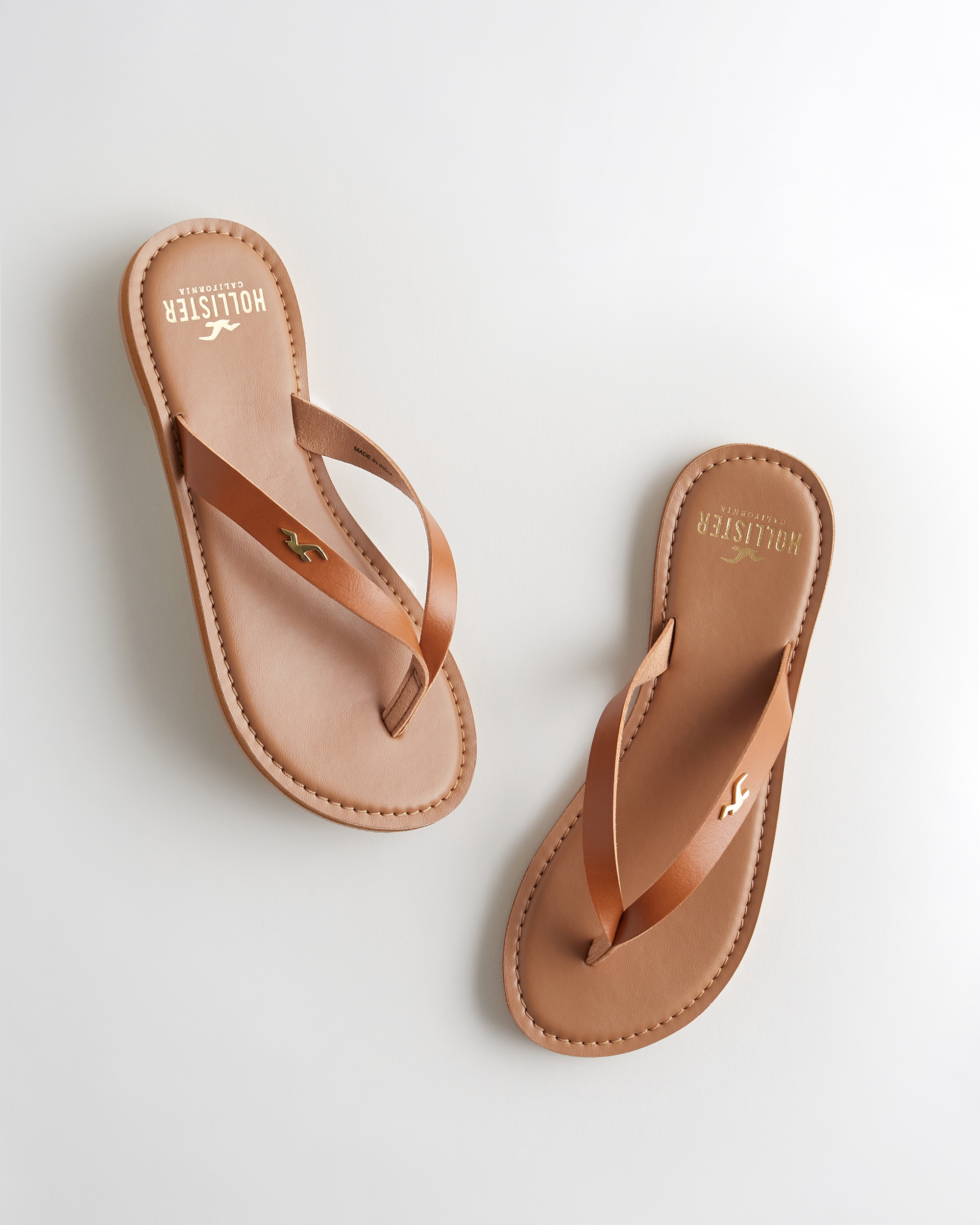 brown leather flip flops