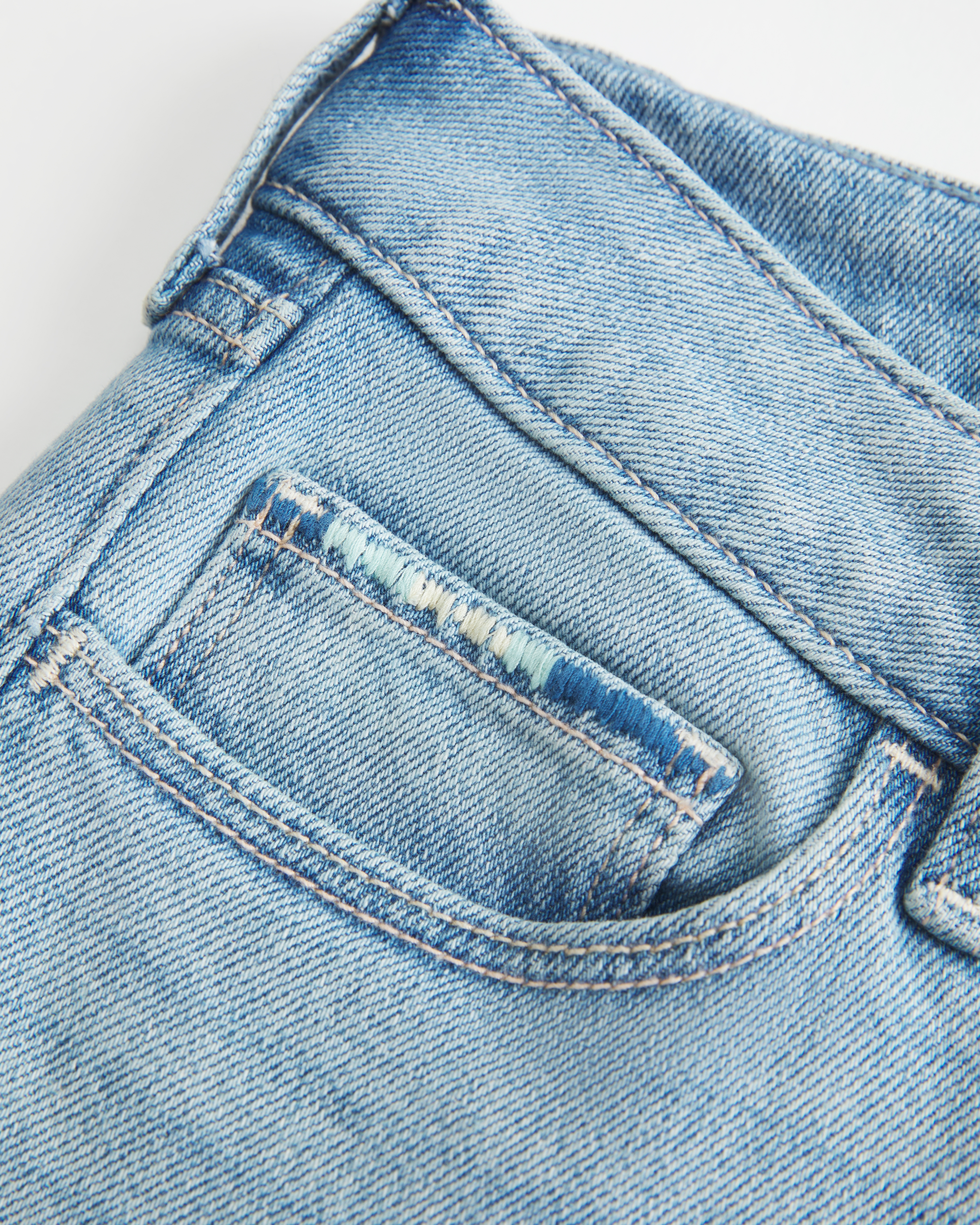 Low-Rise Ripped Light Wash Embroidered Boot Jeans