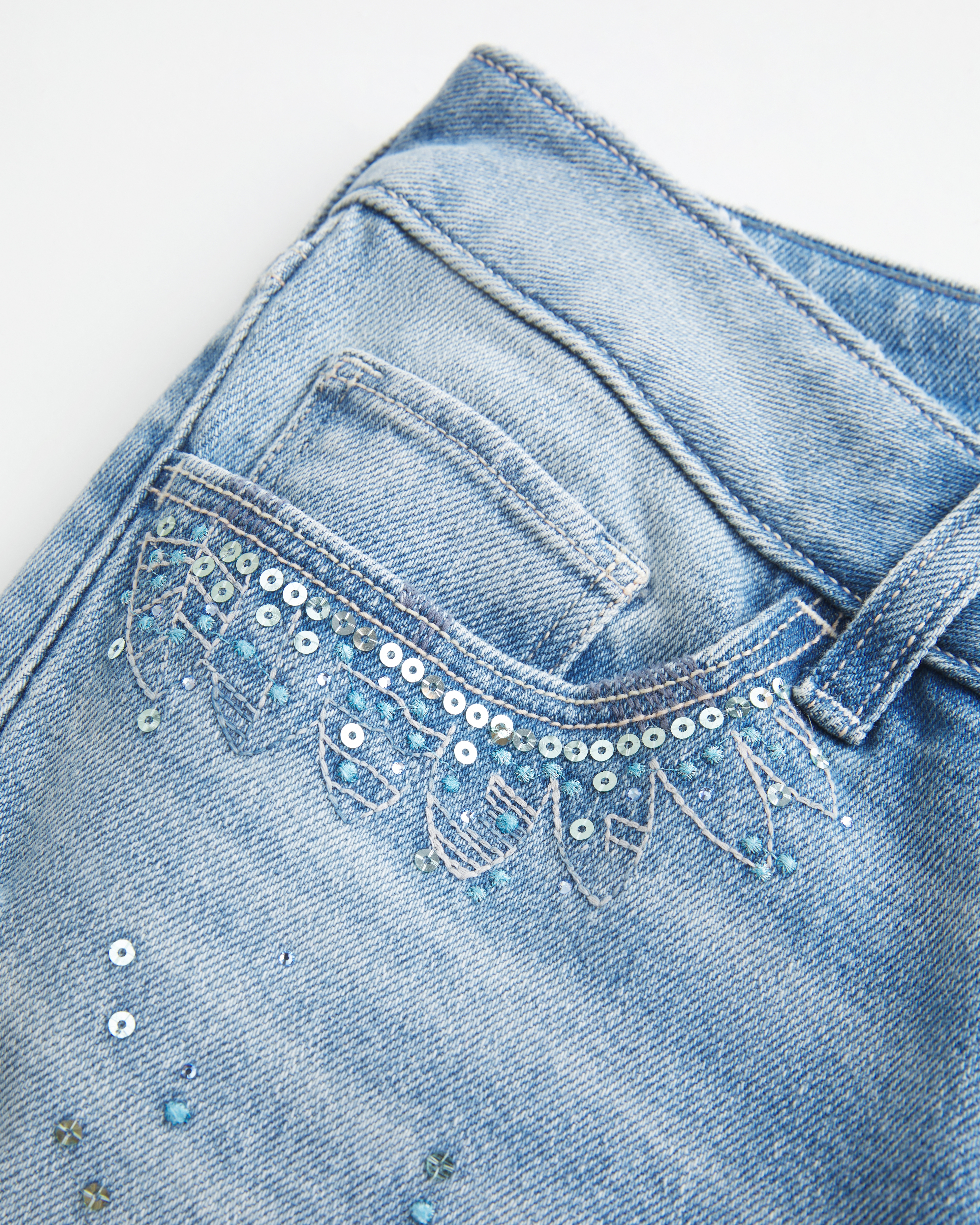 Ultra Low-Rise Distressed Light Wash Sequin Flare Jeans